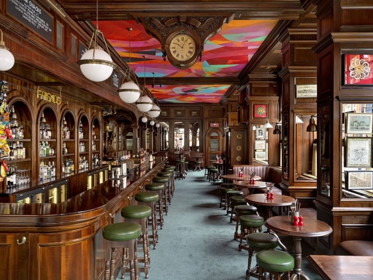 An interior view of the Audley Public House with tables, stools, the bar and Dame Phyllida Barlow's ceiling installation.