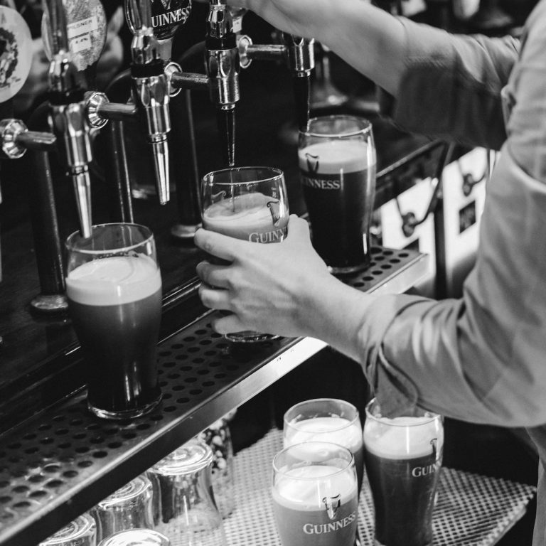 Pints of Guinness being poured at The Audley