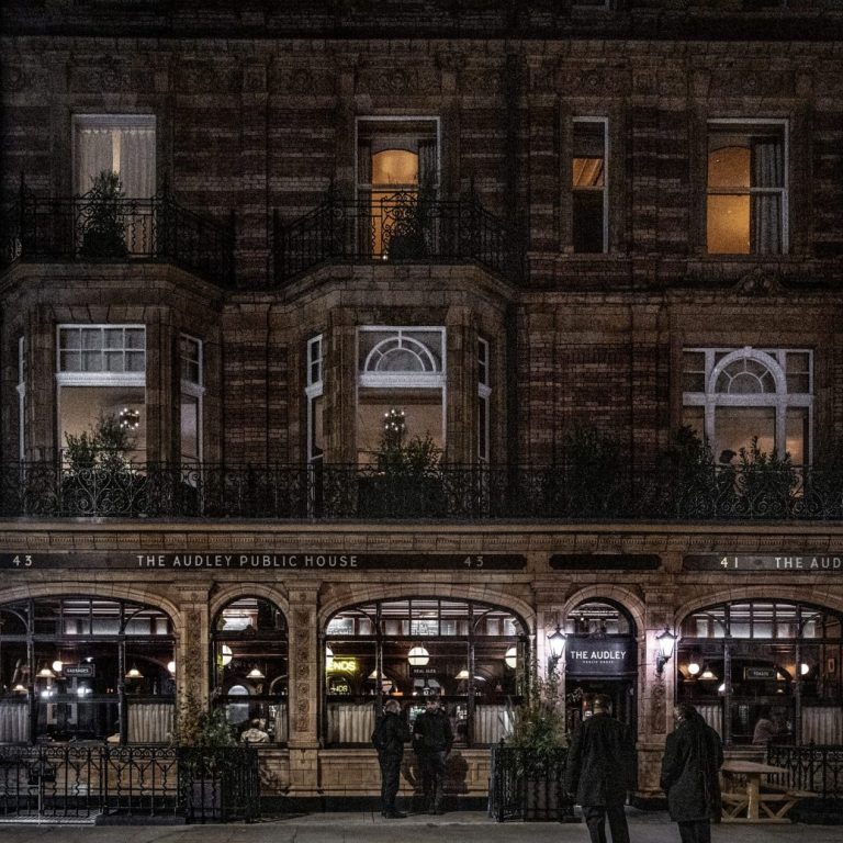 The exterior of The Audley pub at night