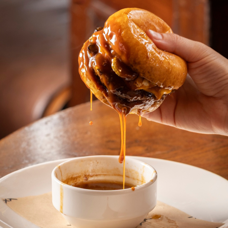 The Audley burger: Aged beef patty, double cheese, caramelised onions, pickled onions & gherkins, horseradish mayonnaise, and beef fat jus dipping sauce.