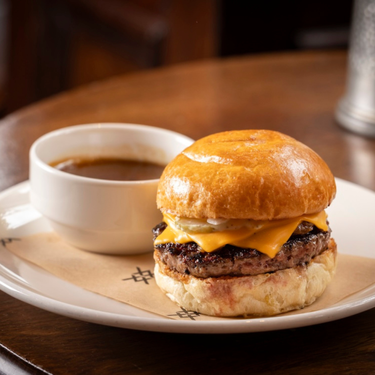 The Audley burger: Aged beef patty, double cheese, caramelised onions, pickled onions & gherkins, horseradish mayonnaise, and beef fat jus dipping sauce.