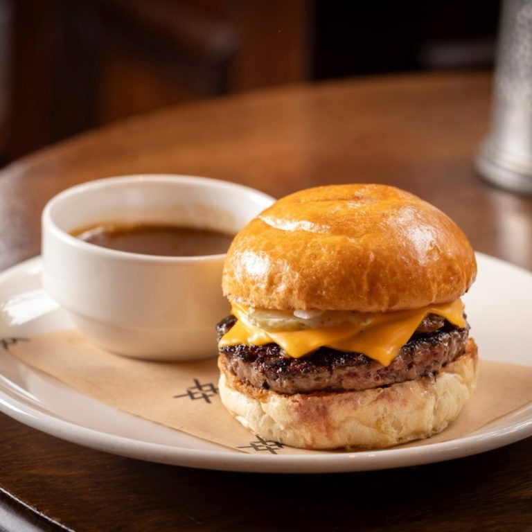 The Audley burger: Aged beef patty, double cheese, caramelised onions, pickled onions & gherkins, horseradish mayonnaise, and beef fat jus dipping sauce.
